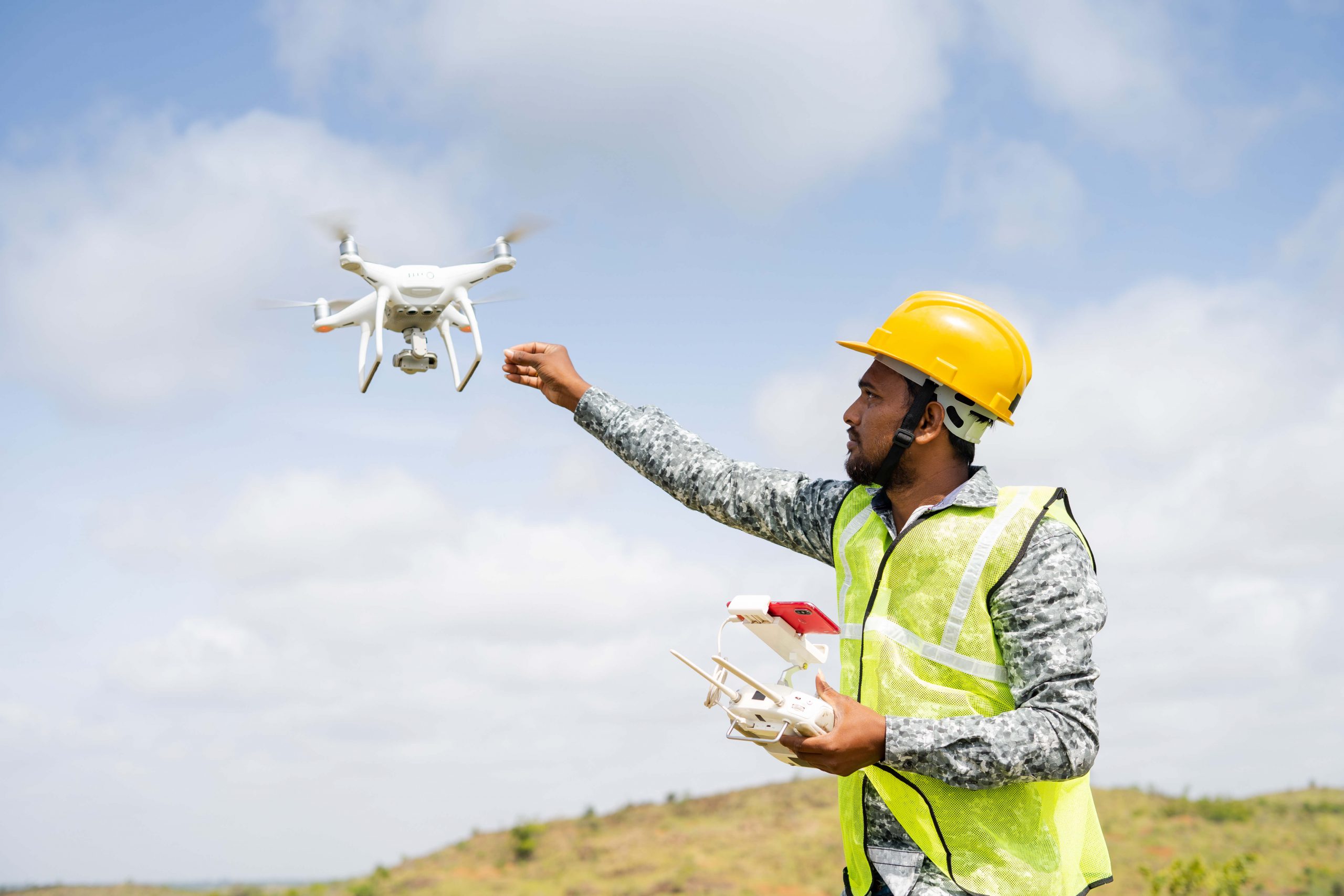pilot deploying drone while holding tablet with mapping app